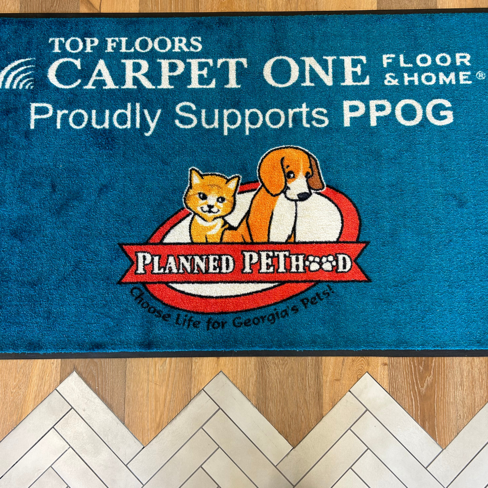 Cute kitty and puppy rug showcasing Top Floors Carpet One's commitment to Planned Pethood, Suwanee, Georgia.